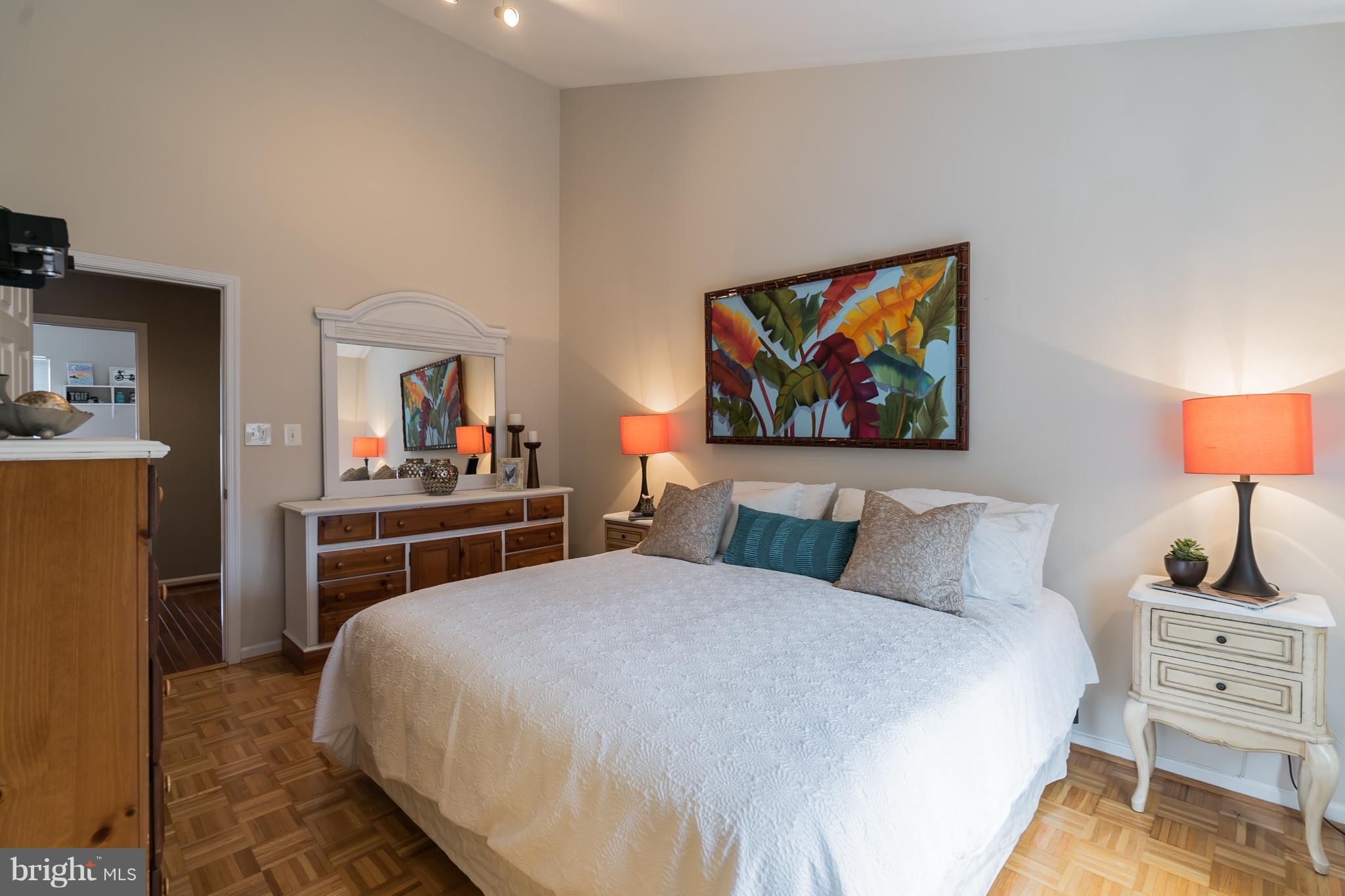 11459 Heritage Commons Way Reston, VA 20194 - Photo 19 of 30 a bedroom with a bed and a lamp on dresser