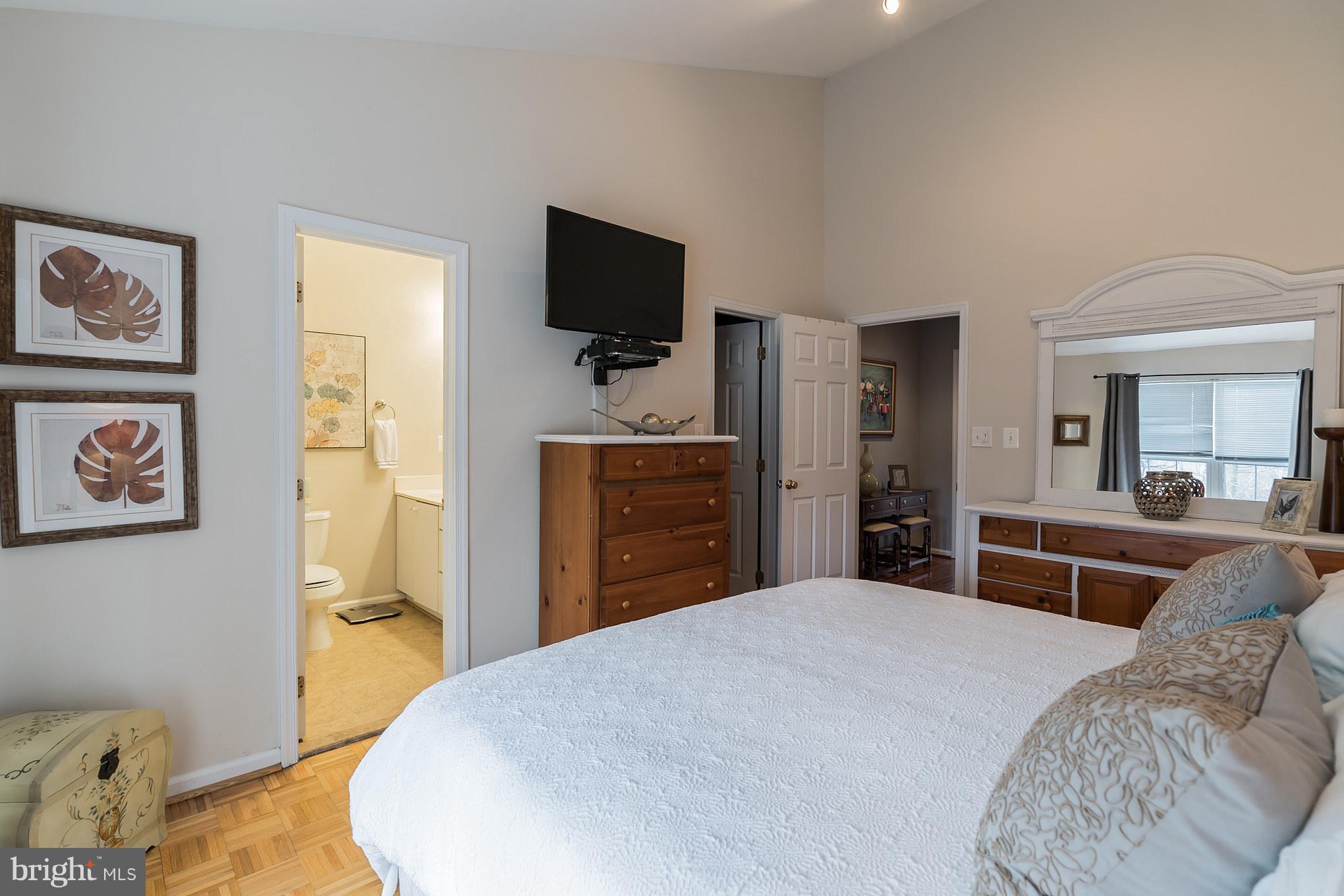 11459 Heritage Commons Way Reston, VA 20194 - Photo 20 of 30 a bedroom with a bed and a flat screen tv
