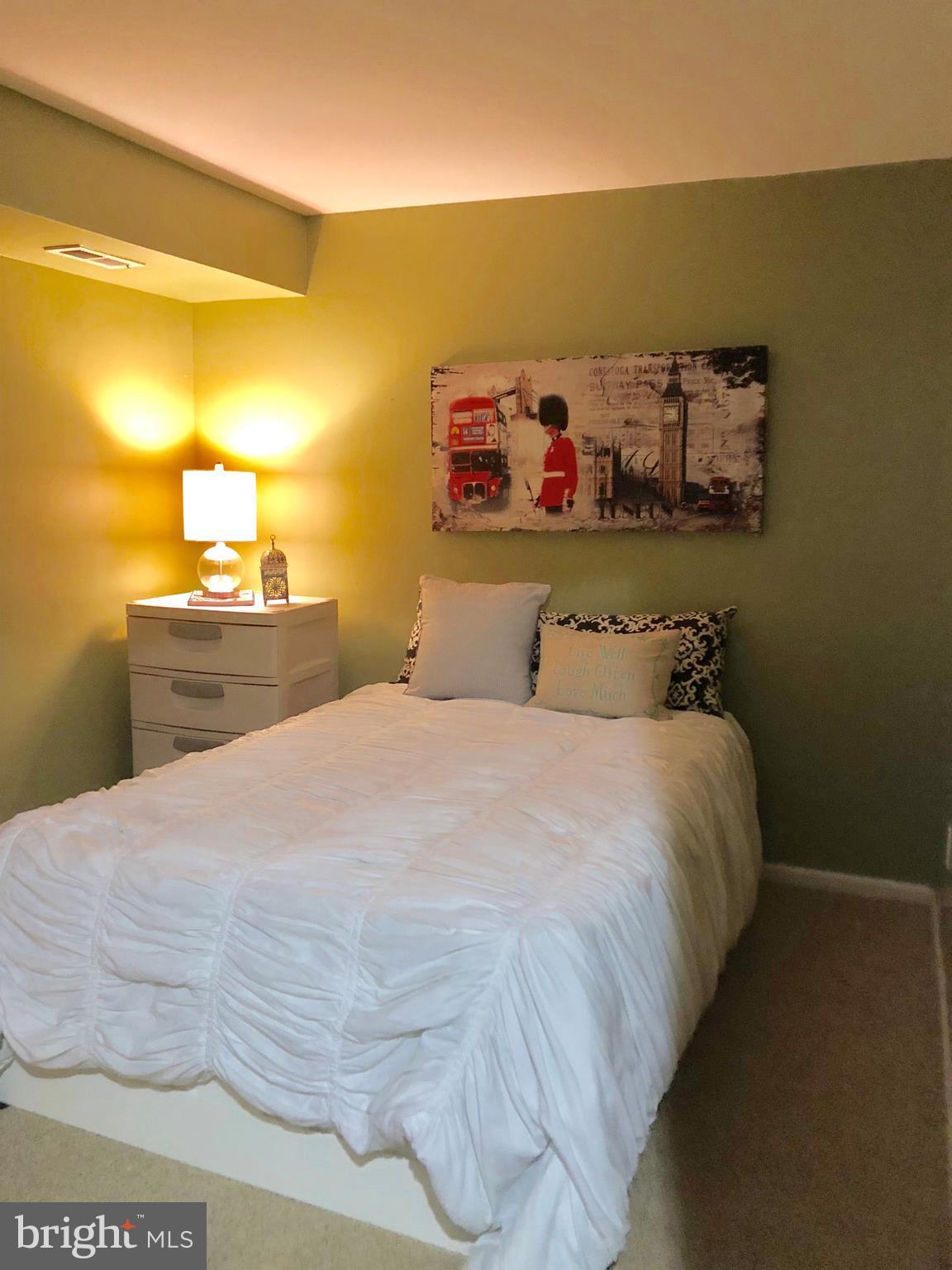 11459 Heritage Commons Way Reston, VA 20194 - Photo 21 of 30 a bedroom with a bed and a night stand