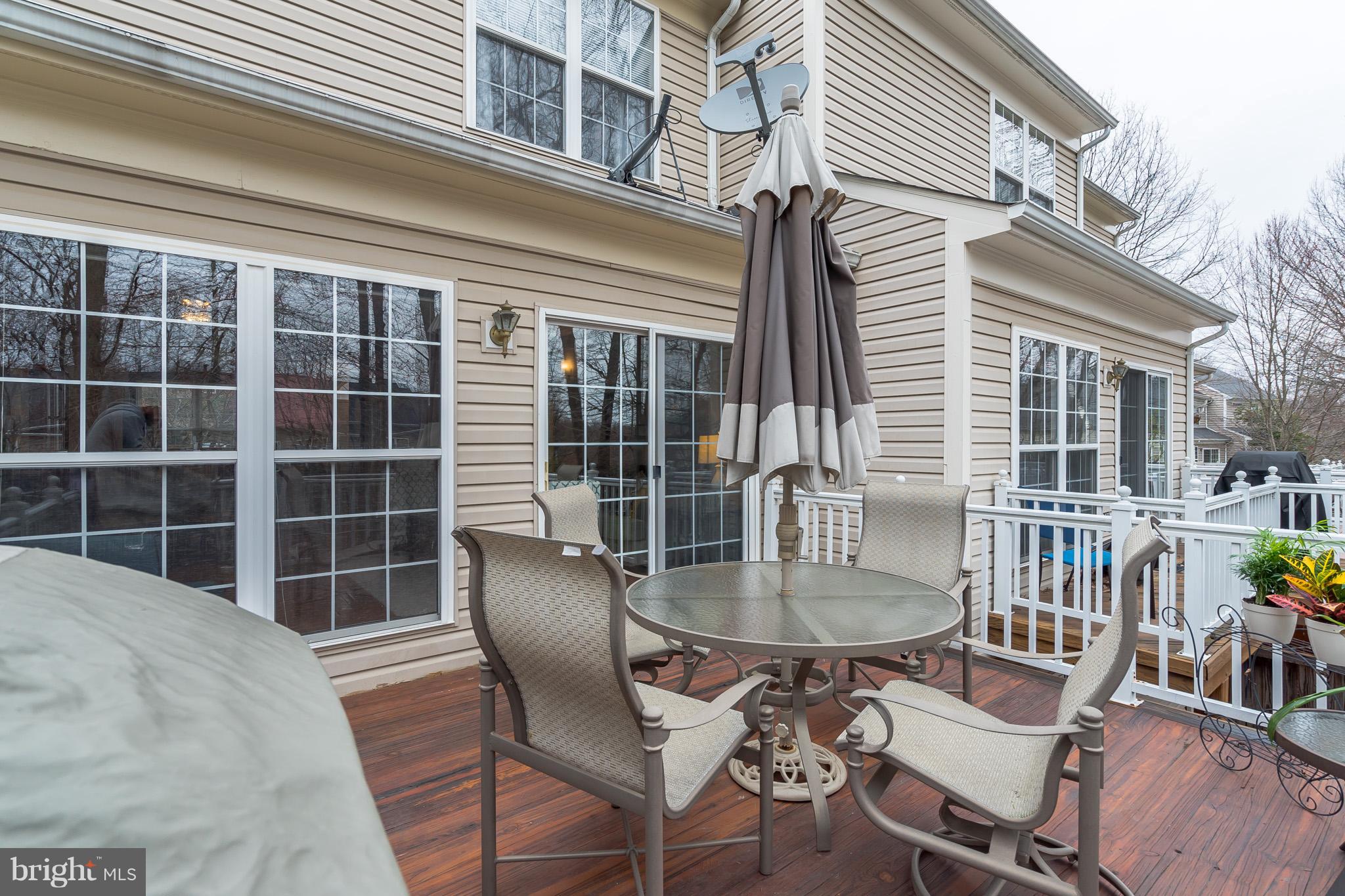 11459 Heritage Commons Way Reston, VA 20194 - Photo 26 of 30 a view of a house with a chairs and table in a patio