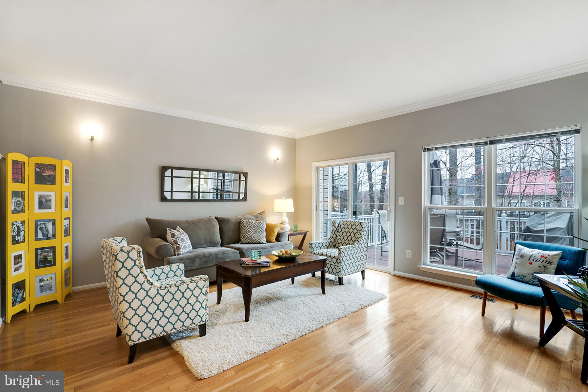 11459 Heritage Commons Way Reston, VA 20194 - Photo 4 of 30 a living room with furniture and a large window with wooden floor