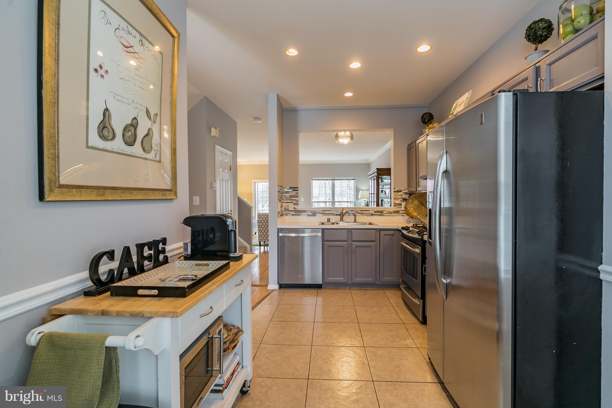 11459 Heritage Commons Way Reston, VA 20194 - Photo 10 of 30 a kitchen with a sink appliances and cabinets