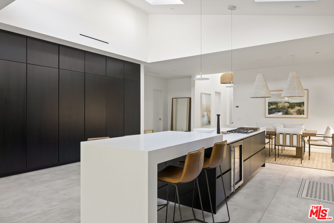 4122 Rhodes Avenue Studio City, CA 91604 - Photo 13 of 39 a large kitchen with kitchen island a sink table and chairs