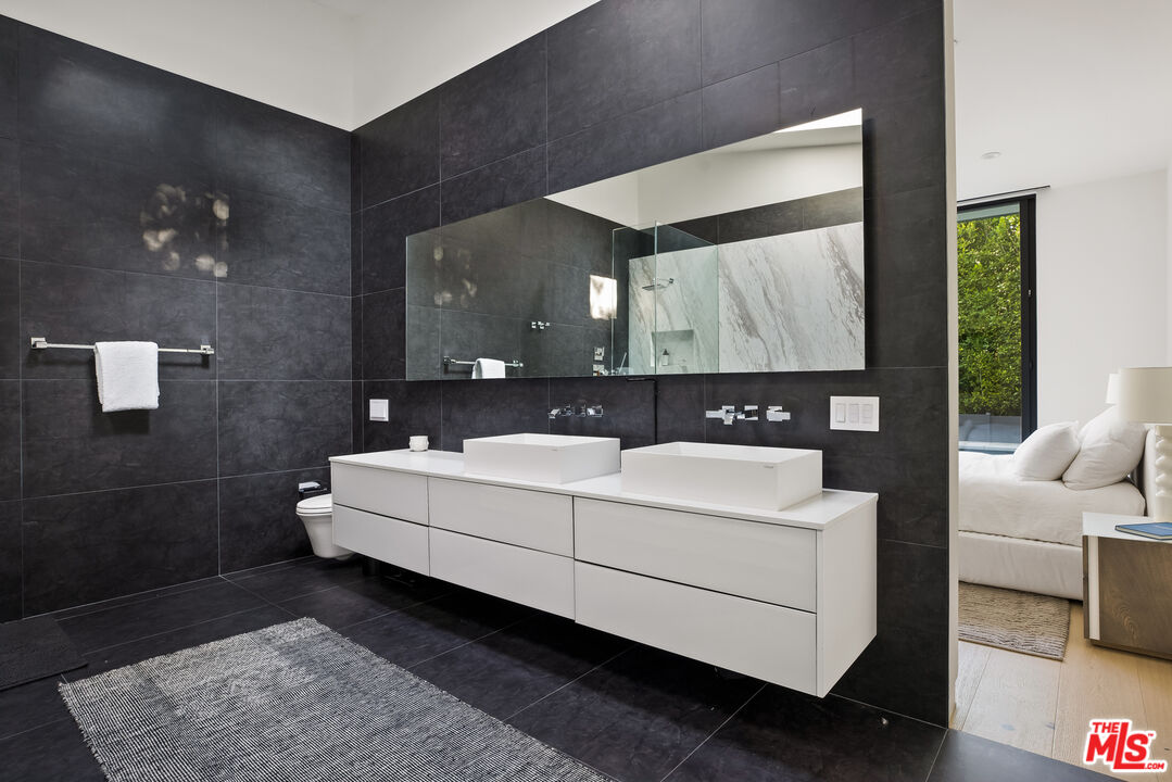 4122 Rhodes Avenue Studio City, CA 91604 - Photo 19 of 39 a bathroom with a sink a mirror and a bathtub