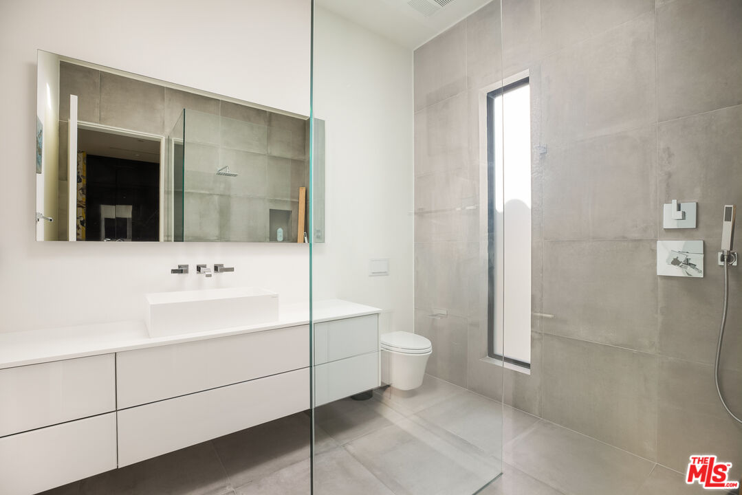 4122 Rhodes Avenue Studio City, CA 91604 - Photo 27 of 39 a bathroom with a sink a toilet and shower