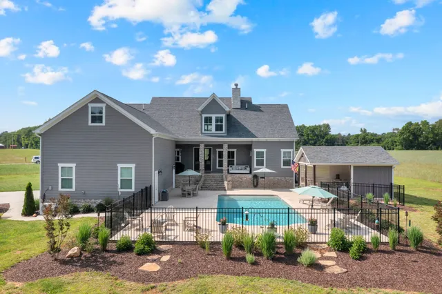a kitchen with stainless steel appliances granite countertop a sink refrigerator and cabinets