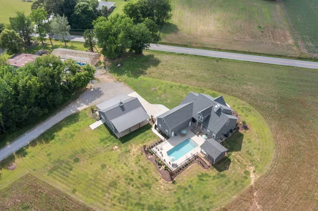 an aerial view of a house with backyard