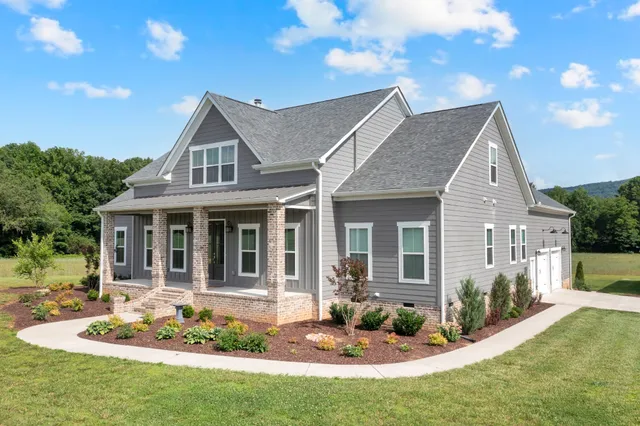 a view of a patio with chairs and table under an umbrella