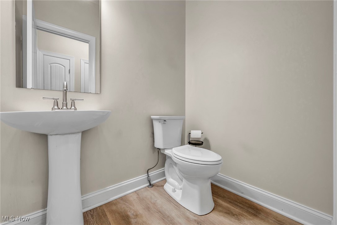 10020 Fair Road Strongsville, OH 44149 - Photo 17 of 47 Half bath with baseboards and light wood-type flooring