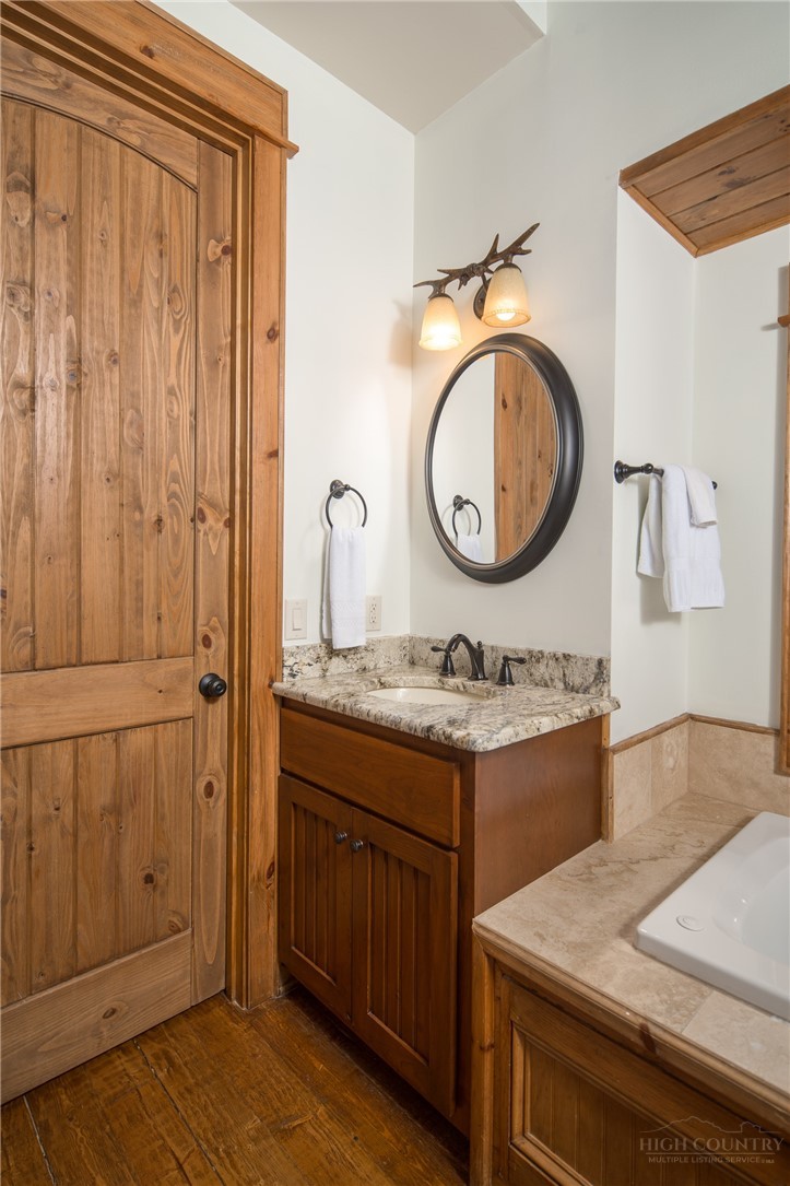 153 Stonecrop Lane Boone, NC 28607 - Photo 18 of 50 a bathroom with a granite countertop sink and a mirror