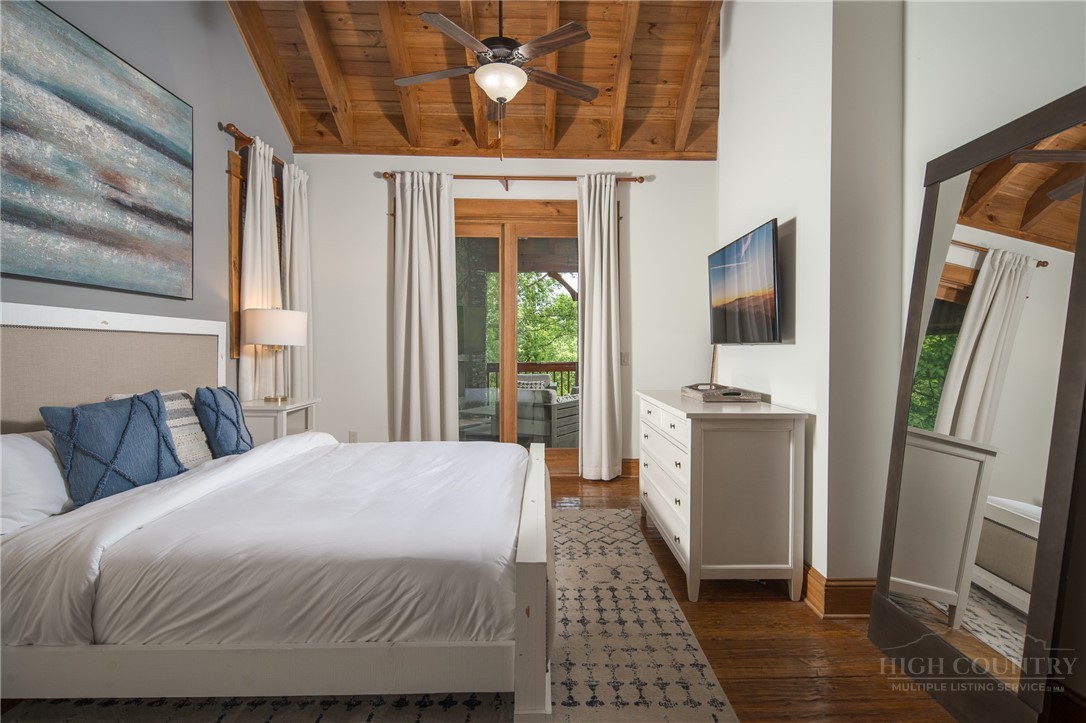 153 Stonecrop Lane Boone, NC 28607 - Photo 28 of 50 a bedroom with a bed and a flat screen tv