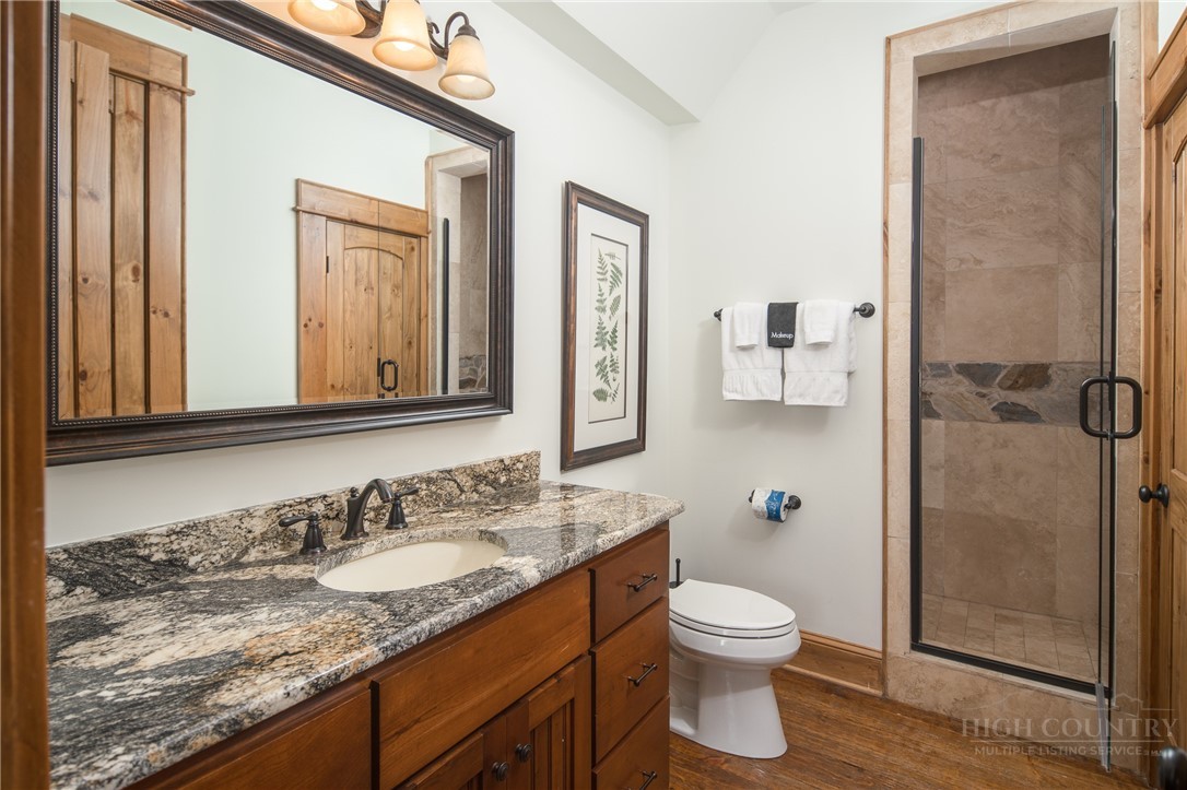 153 Stonecrop Lane Boone, NC 28607 - Photo 31 of 50 a bathroom with a granite countertop sink toilet and shower