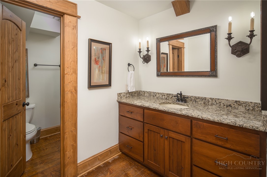 153 Stonecrop Lane Boone, NC 28607 - Photo 38 of 50 a bathroom with a granite countertop sink mirror and vanity