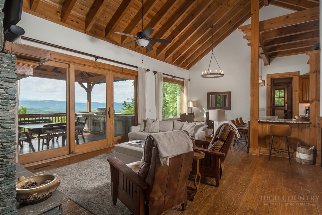 153 Stonecrop Lane Boone, NC 28607 - Photo 5 of 50 a living room with furniture and a floor to ceiling window