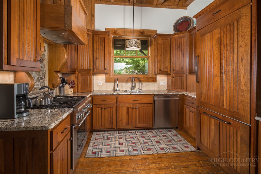 153 Stonecrop Lane Boone, NC 28607 - Photo 9 of 50 a kitchen with a sink stove and cabinets