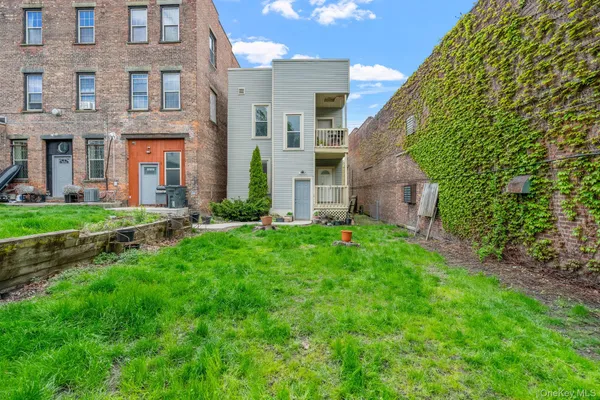 a view of a brick building next to a yard