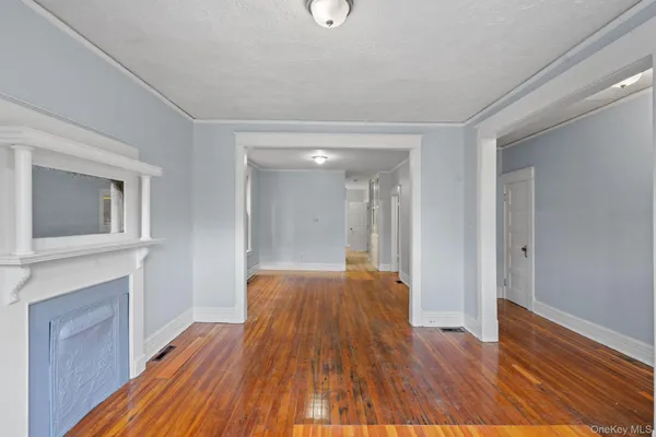 a view of a livingroom with wooden floor and staircase