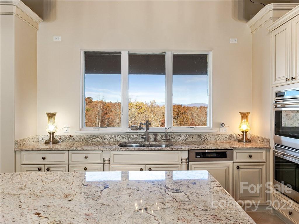 3135 Polk County Line Road Rutherfordton, NC 28139 - Photo 29 of 48 a kitchen with stainless steel appliances kitchen island granite countertop a sink and a stove