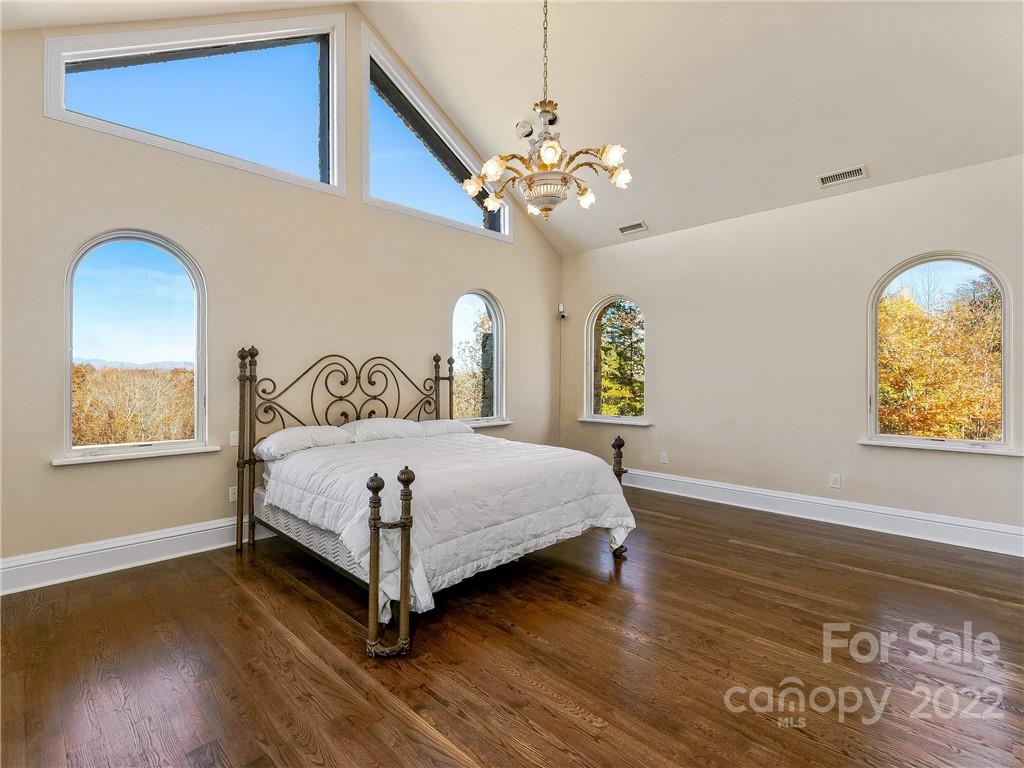 3135 Polk County Line Road Rutherfordton, NC 28139 - Photo 39 of 48 a bedroom with a bed chandelier and a window