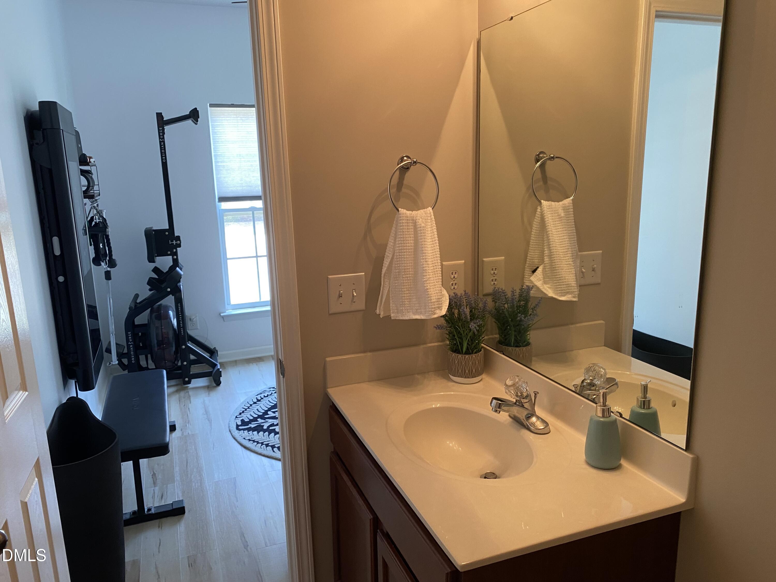 9826 Layla Avenue Raleigh, NC 27617 - Photo 15 of 19 a bathroom with a sink vanity and mirror