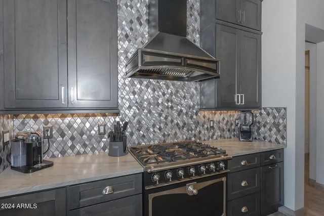 a view of a stove and wooden cabinets