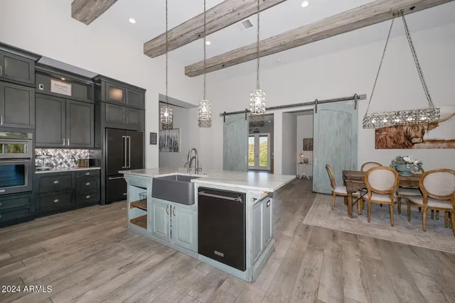 a large kitchen with a table and chairs