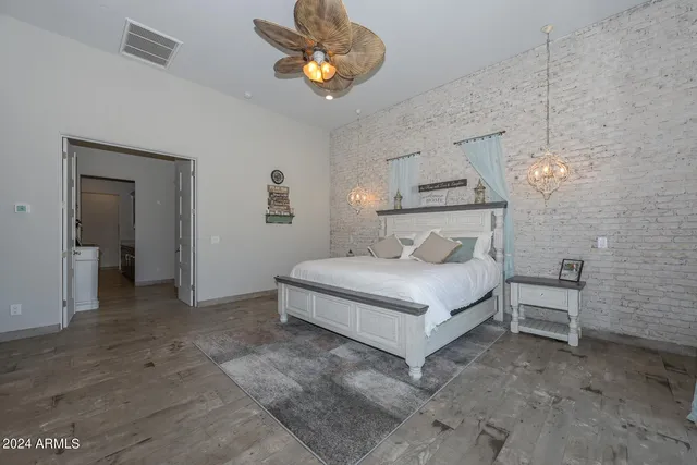 a bedroom with a bed and a chandelier