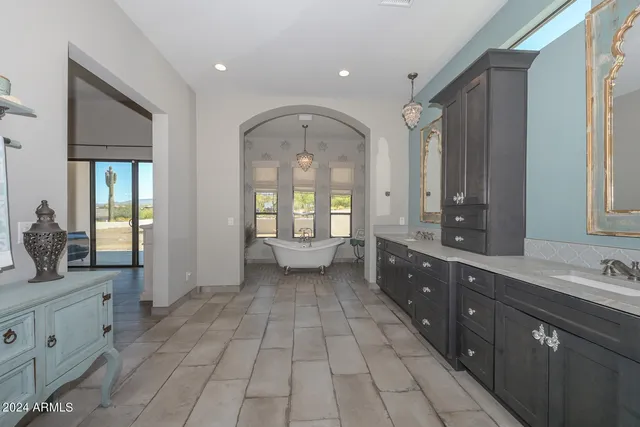 a large bathroom with a double vanity sink and a mirror