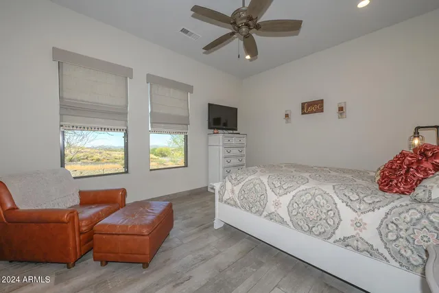 a bedroom with a bed and a couch