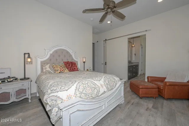 a bathroom with a granite countertop sink a toilet and a mirror
