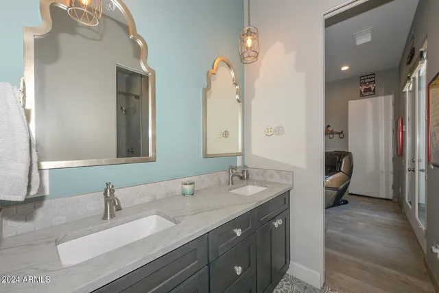 a bathroom with a double vanity sink and a mirror