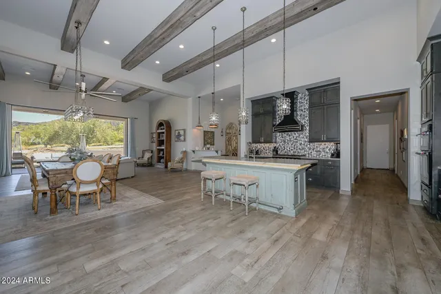 a large kitchen with a table and chairs in it