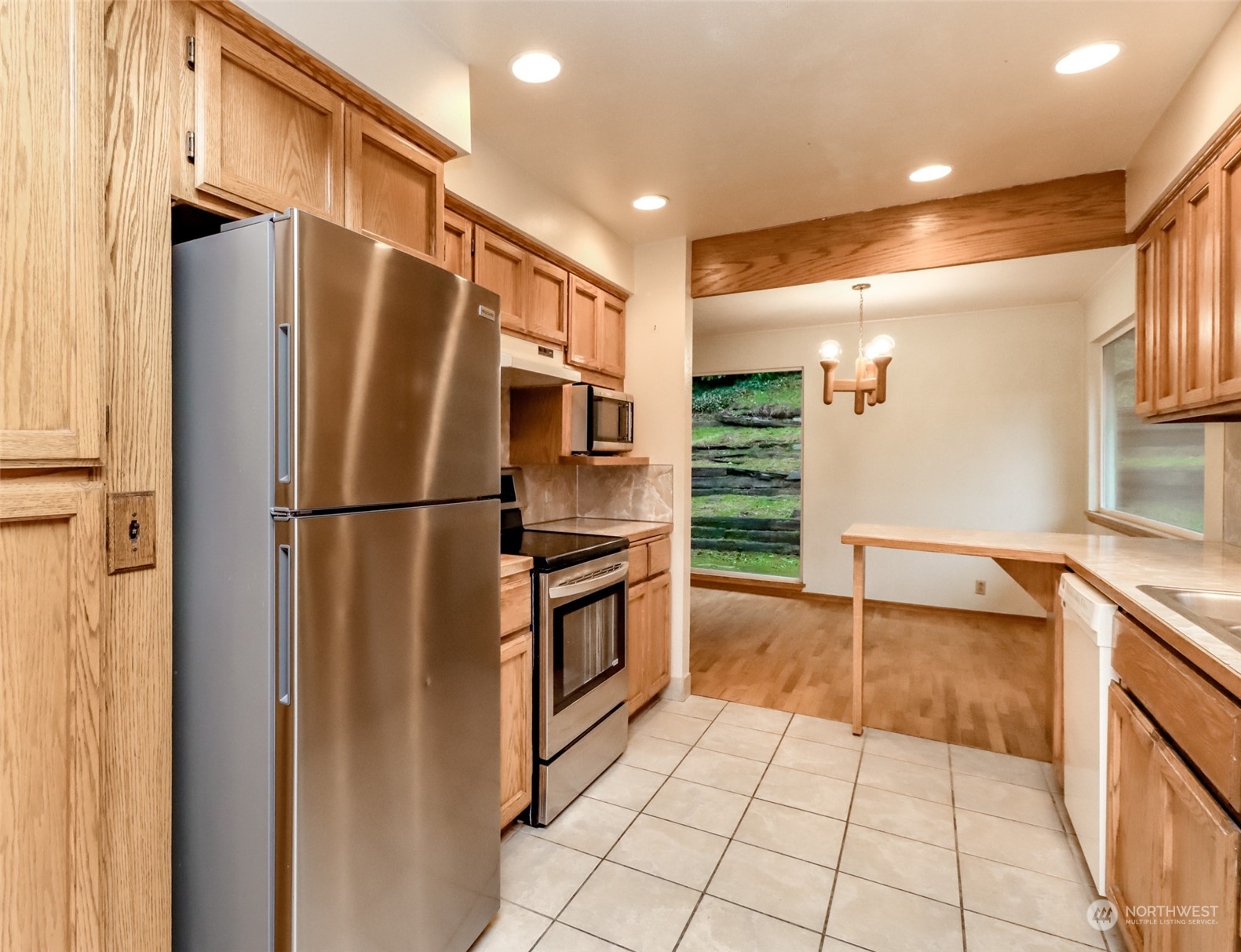 425 Ramsdell Street Fircrest, WA 98466 - Photo 16 of 39 a kitchen with stainless steel appliances a refrigerator and a sink