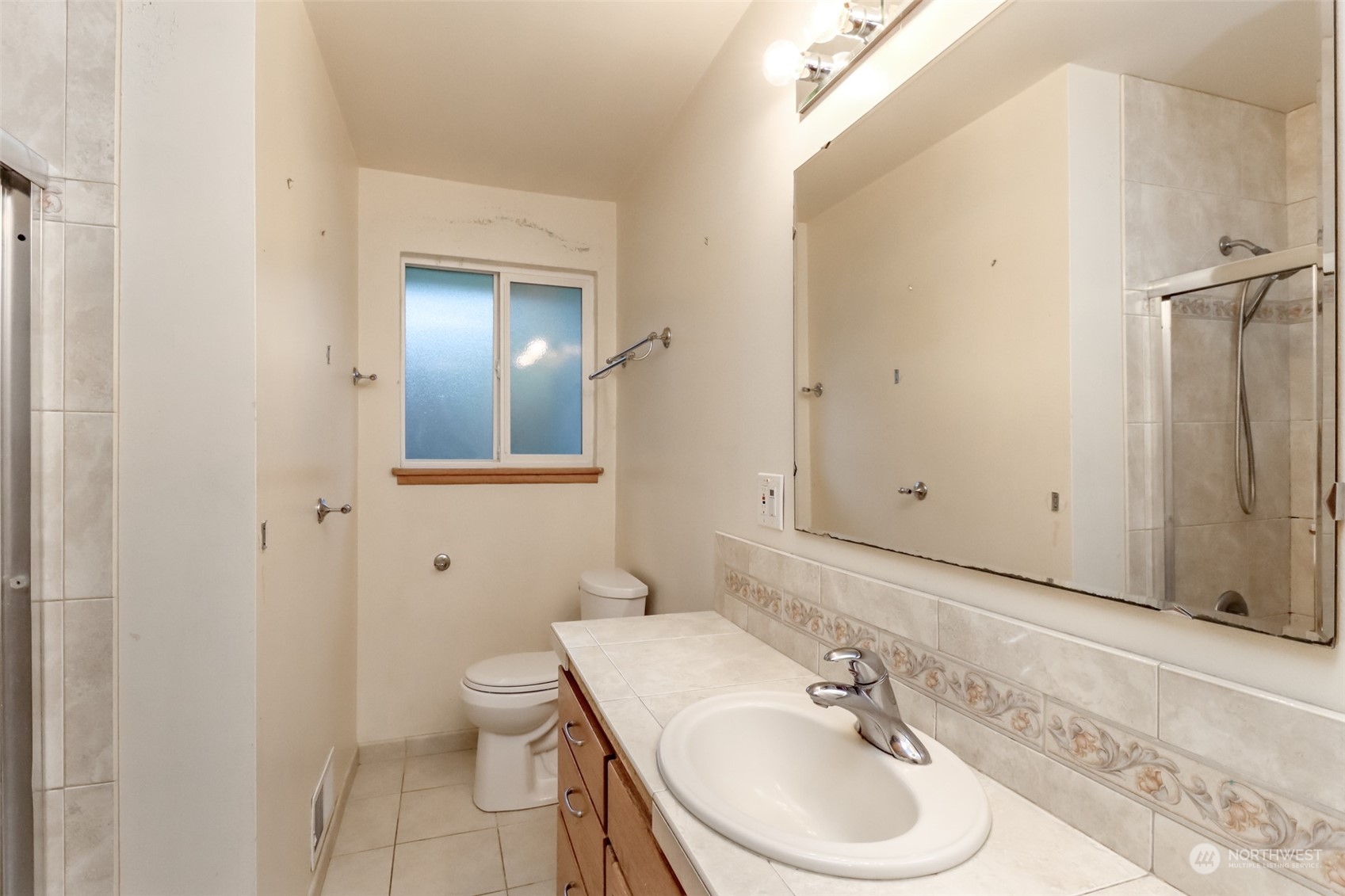 425 Ramsdell Street Fircrest, WA 98466 - Photo 18 of 39 a bathroom with a toilet a sink and a mirror