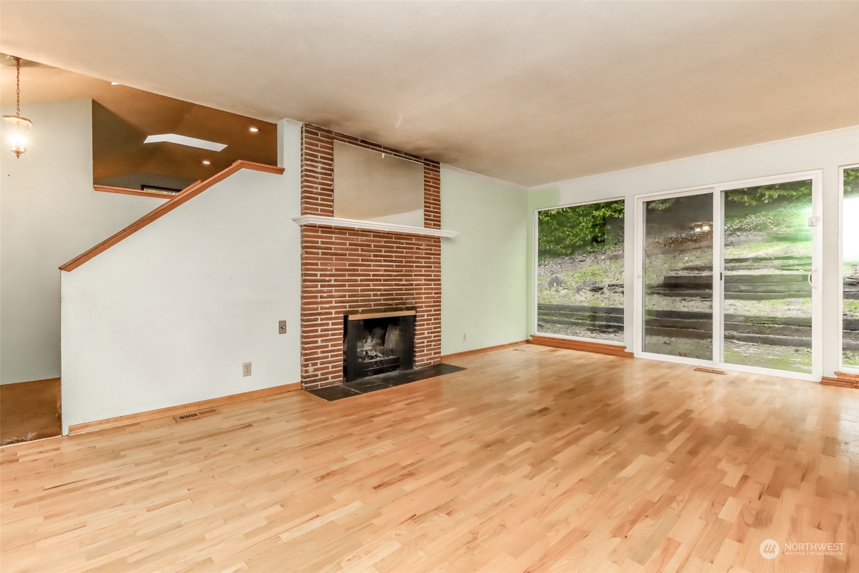 425 Ramsdell Street Fircrest, WA 98466 - Photo 7 of 39 a view of empty room with wooden floor and fireplace