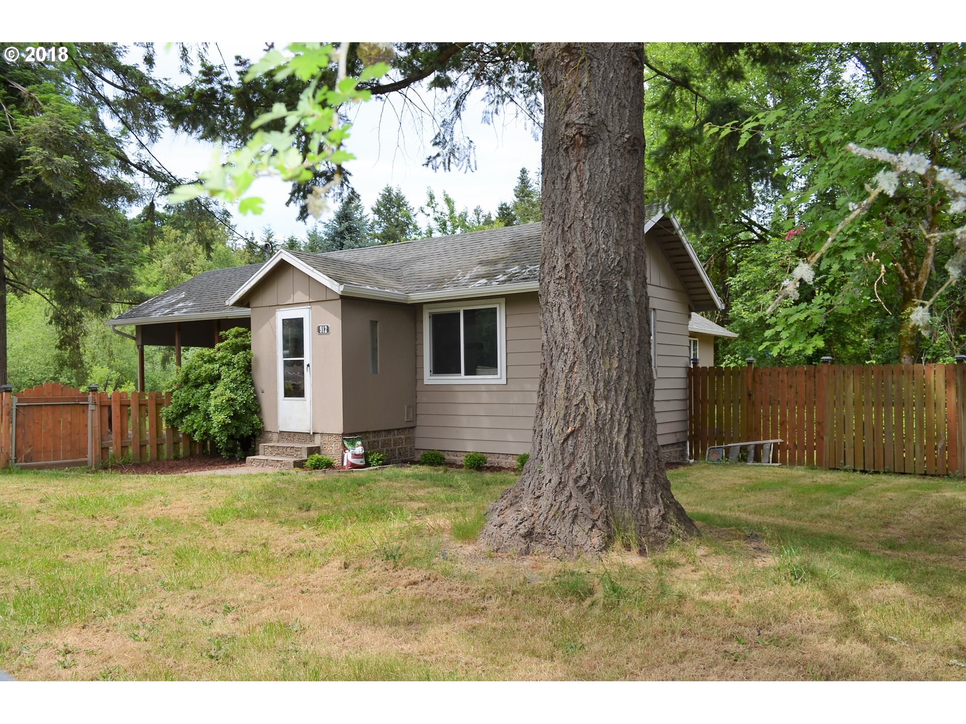 912 Northeast 194th Street Ridgefield, WA 98642 - Photo 1 of 29 a view of a yard in front of a house with large tree