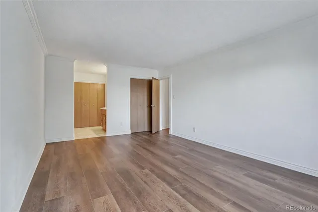 a view of walk in closet with empty racks