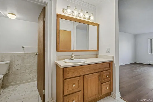 a white toilet sitting next to a shower in a bathroom