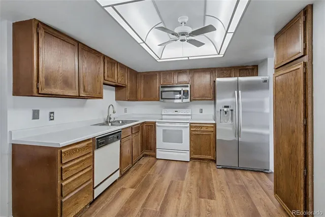 a kitchen with kitchen island granite countertop stainless steel appliances cabinets a sink and a counter top space
