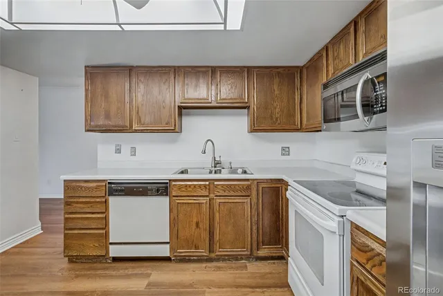 a kitchen with a sink cabinets and stainless steel appliances