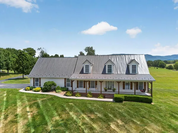 a front view of house with yard and green space