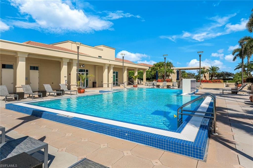 9123 Strada Place, Unit 7201 Naples, FL 34108 - Photo 38 of 50 a view of a swimming pool with a bench and floor to ceiling window