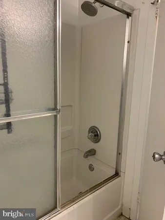 a bathroom with a shower and a sink