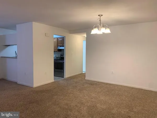 a view of an empty room with an entryway