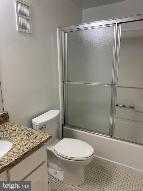 626 South Charles Street, Unit R 25 Baltimore, MD 21230 - Photo 10 of 17 a bathroom with a granite countertop toilet and a shower