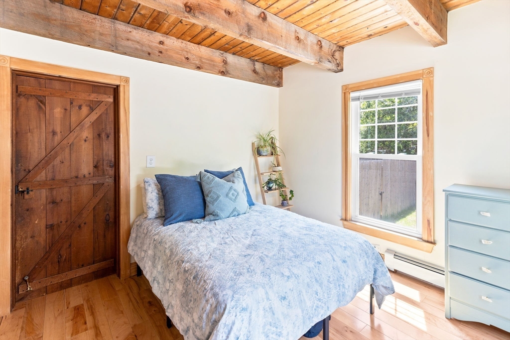 1020 Old Falmouth Road Barnstable, MA 02632 - Photo 31 of 42 a bed sitting in a bedroom next to a window