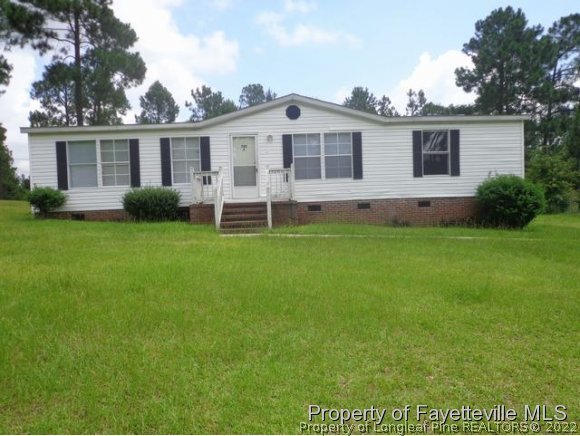 705 Winding Ridge Sanford, NC 27332 - Photo 1 of 10 a view of a house with a yard and porch