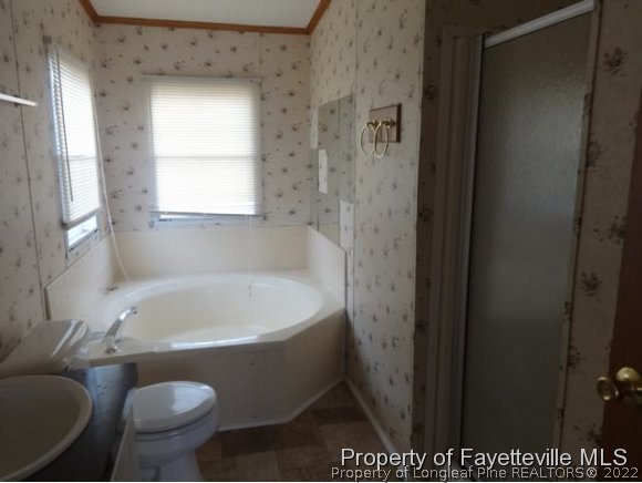 705 Winding Ridge Sanford, NC 27332 - Photo 9 of 10 a bathroom with a tub and sink
