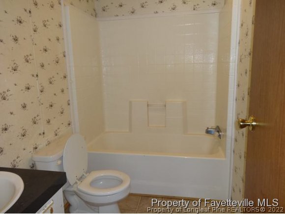 705 Winding Ridge Sanford, NC 27332 - Photo 10 of 10 a bathroom with a toilet and a shower