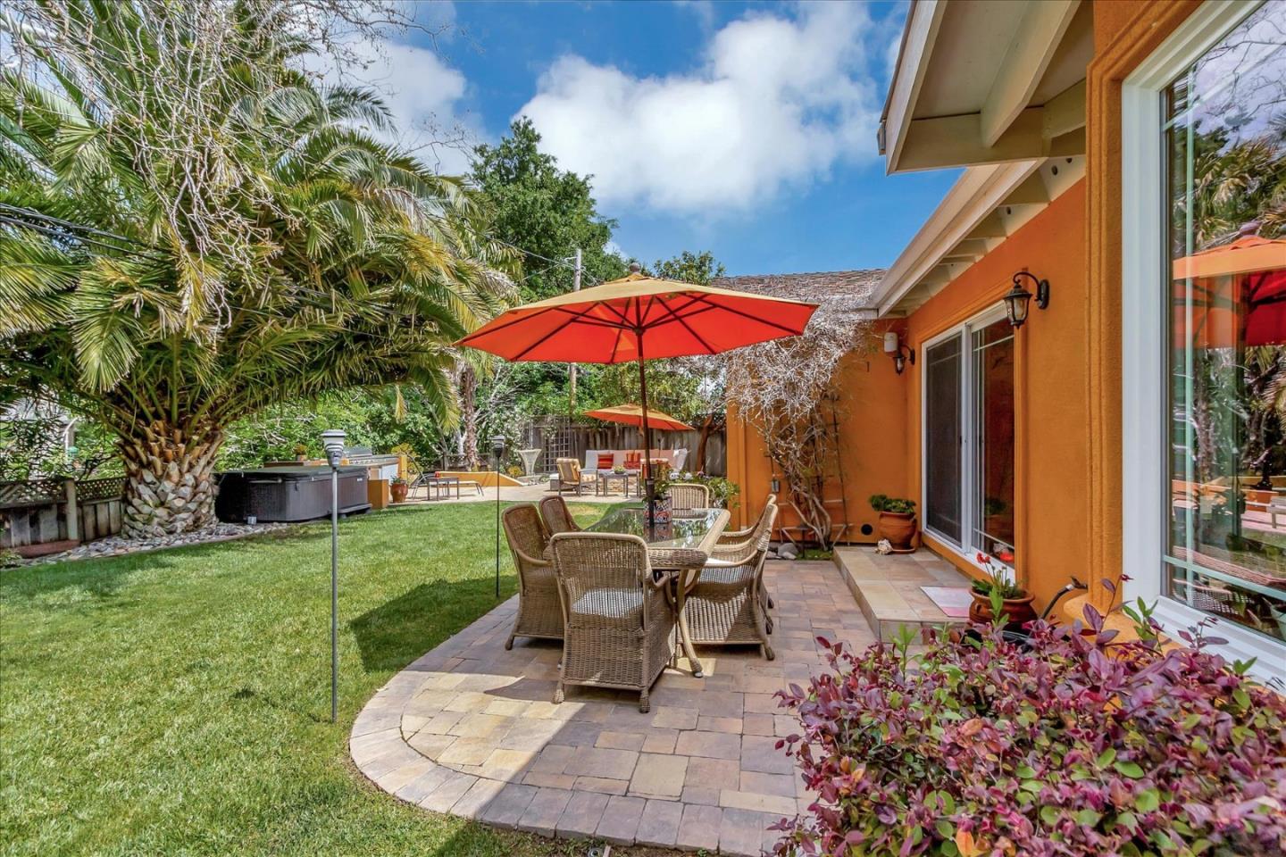 10181 Phar Lap Drive Cupertino, CA 95014 - Photo 7 of 9 a view of a house with backyard sitting area and garden